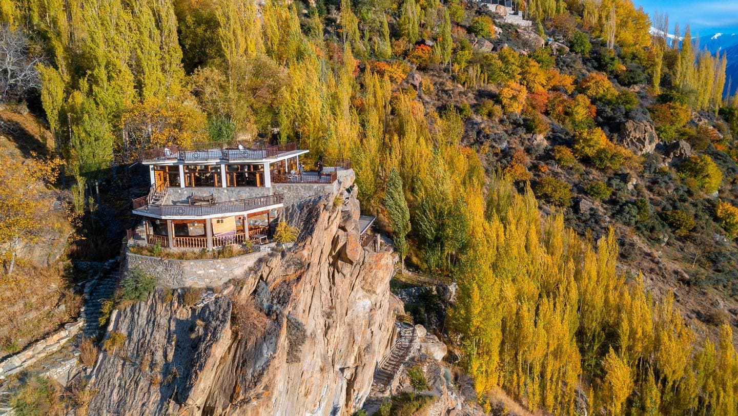 Offsite.Living cliffside property surrounded by autumn trees