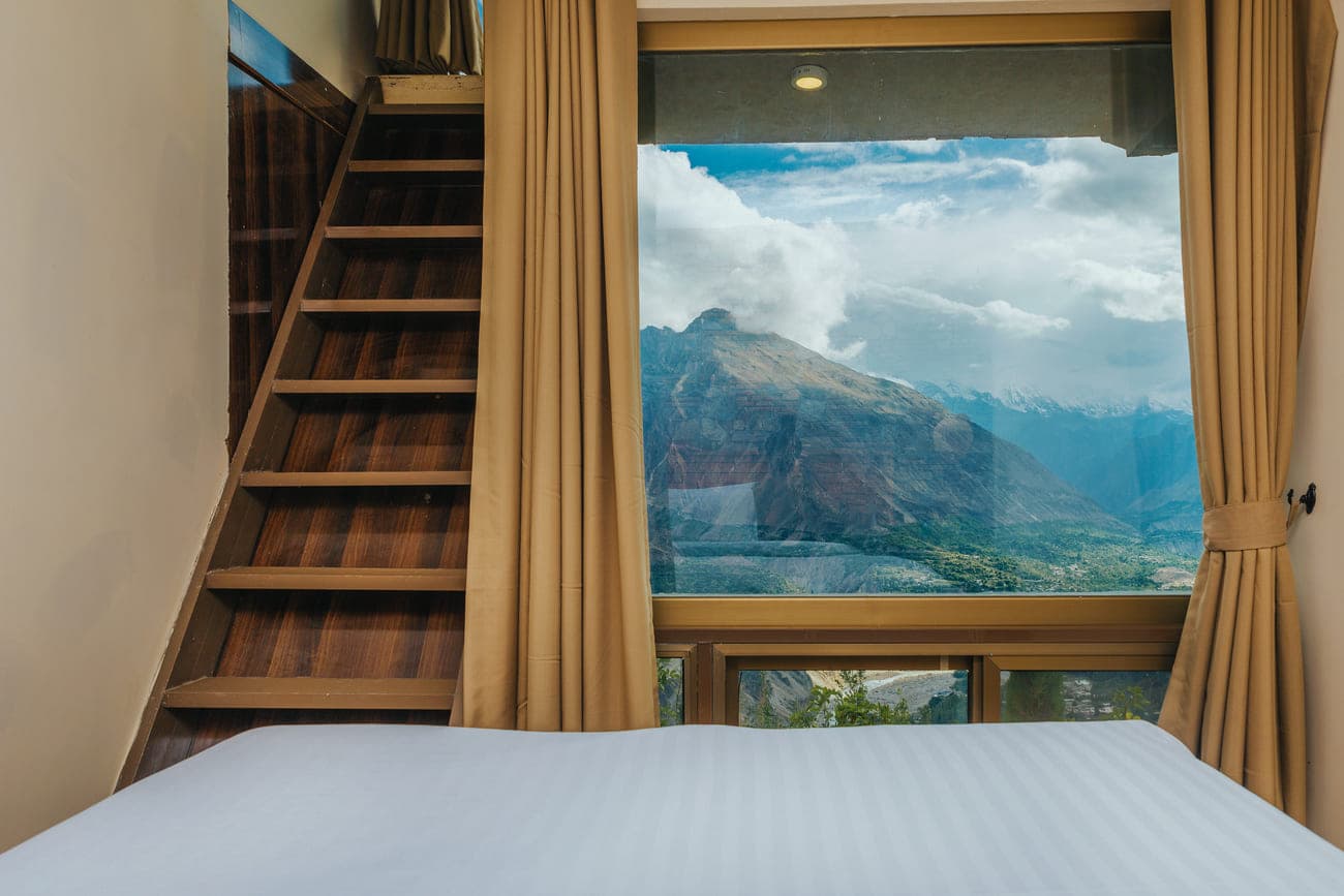Room with staircase loft and panoramic window view